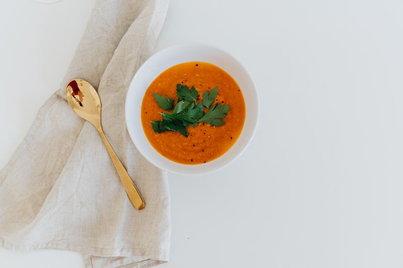 Bowl of hearty tomato soup garnished with fresh herbs